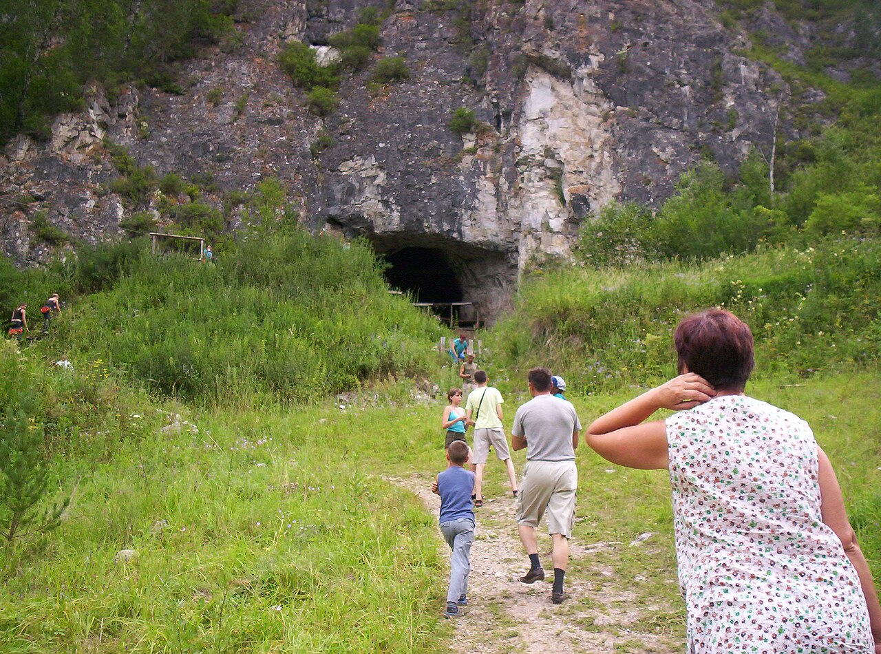 Tourists at the entrance to Denisova Cave, Russia