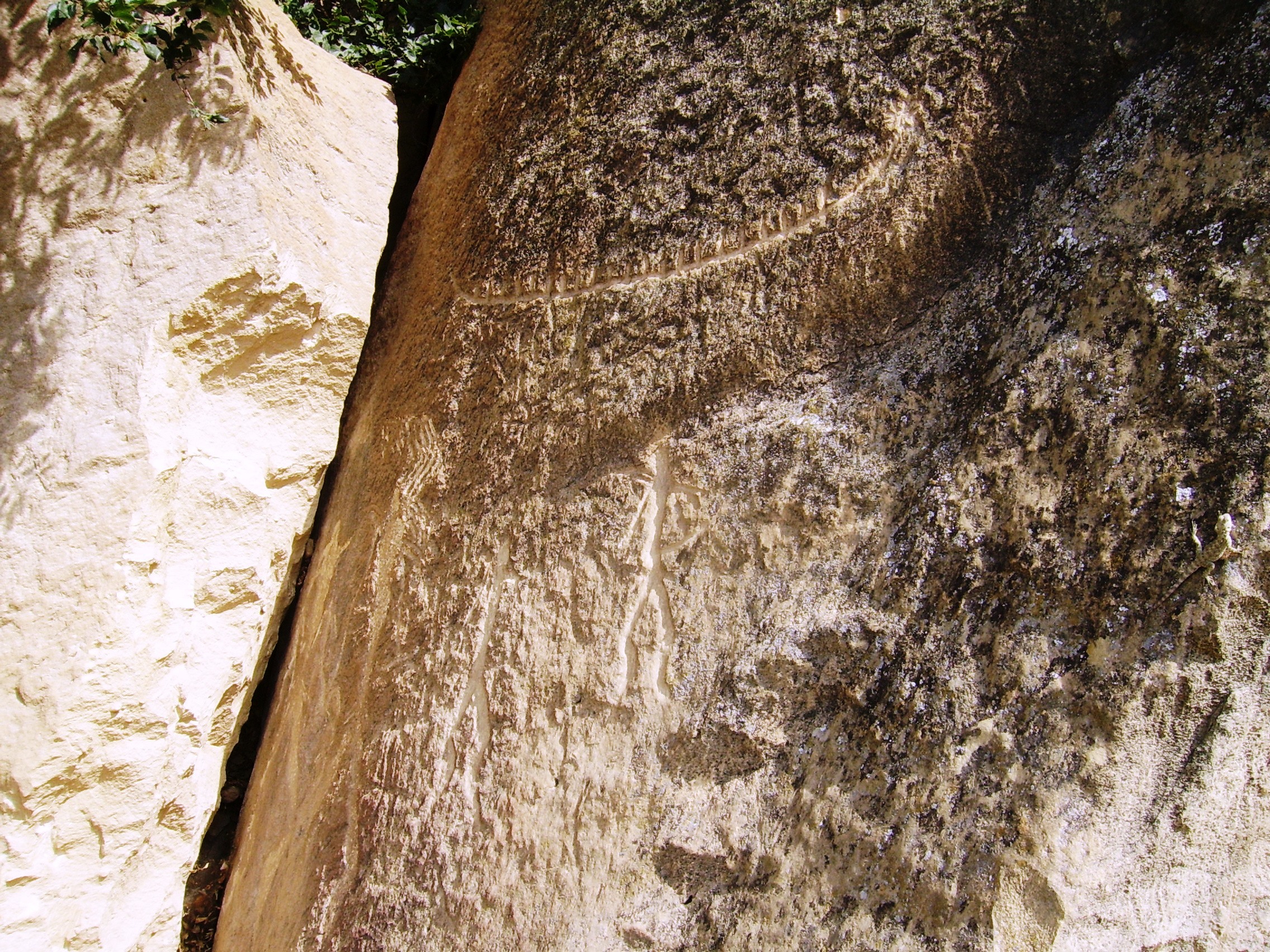 A rock carving of people and a boat at Gobustan