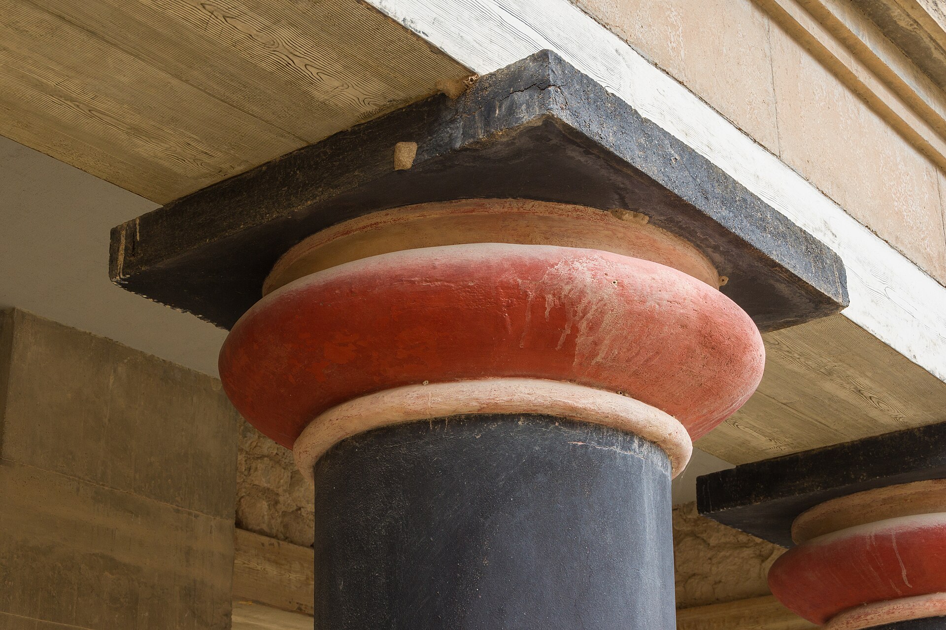 The distinctive downward-tapering red columns of the Knossos throne-room complex, a hallmark of Minoan architecture.
