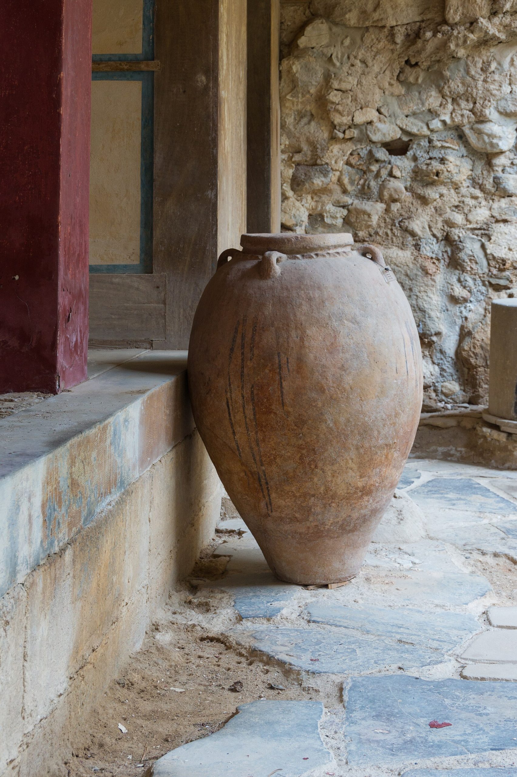A great storage jar, or pithos, at Knossos — the kind of vessel that held the oil, wine, and grain that fuelled Minoan trade across the sea.