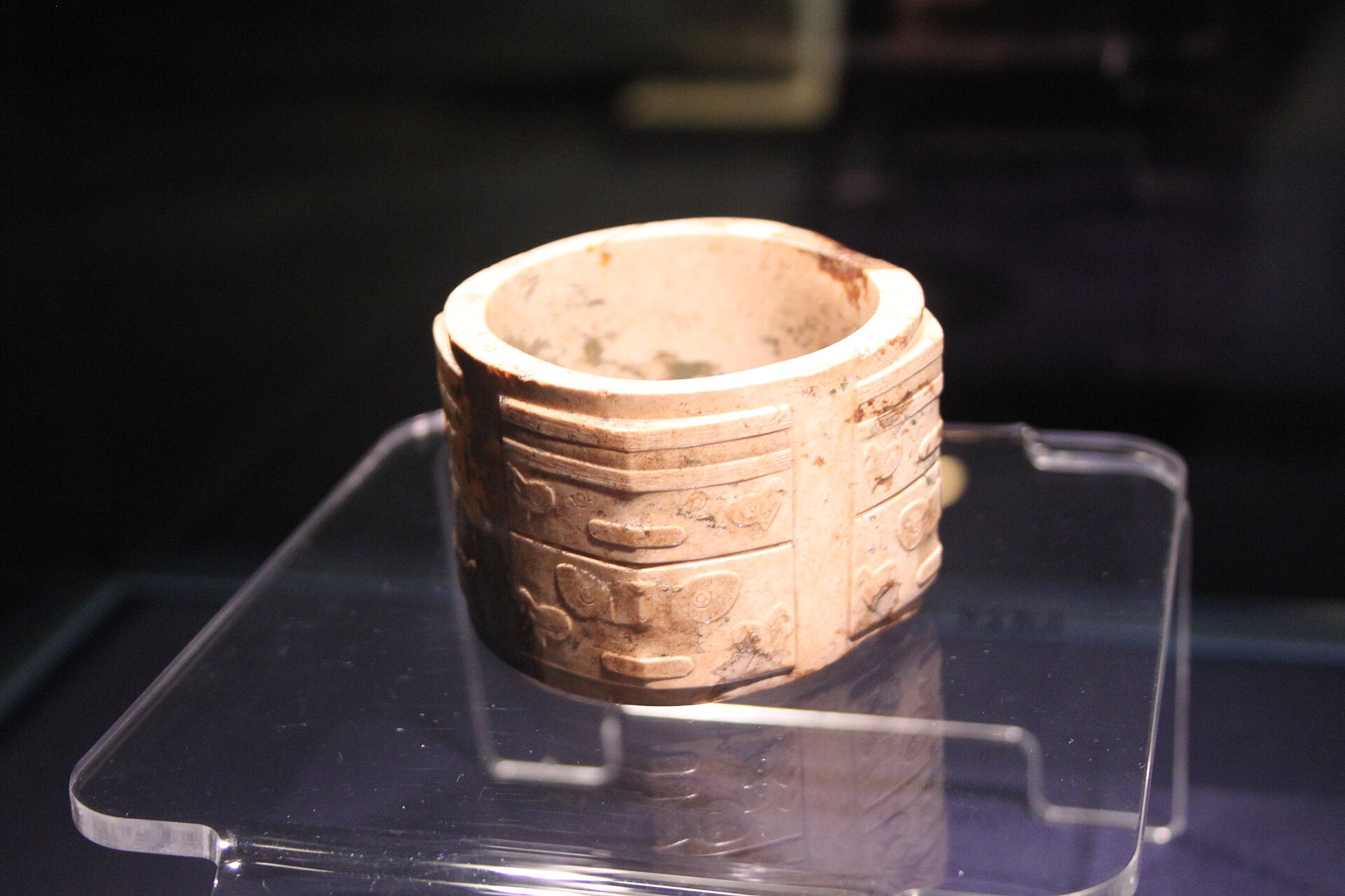 The intricate surface of a Liangzhu jade cong, ground and incised by hand with tools softer than the stone itself.