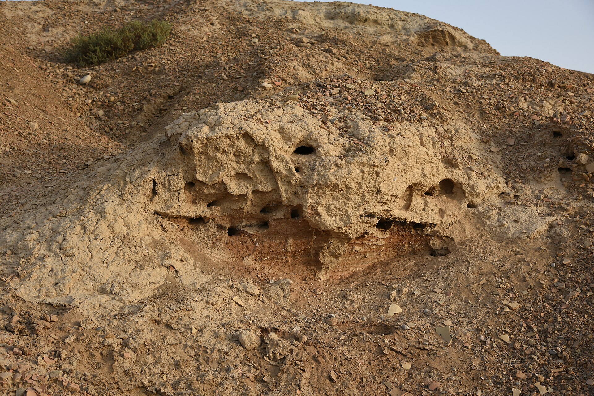 Weathered earthen walls, the low remnants of a settlement that began some nine thousand years ago.