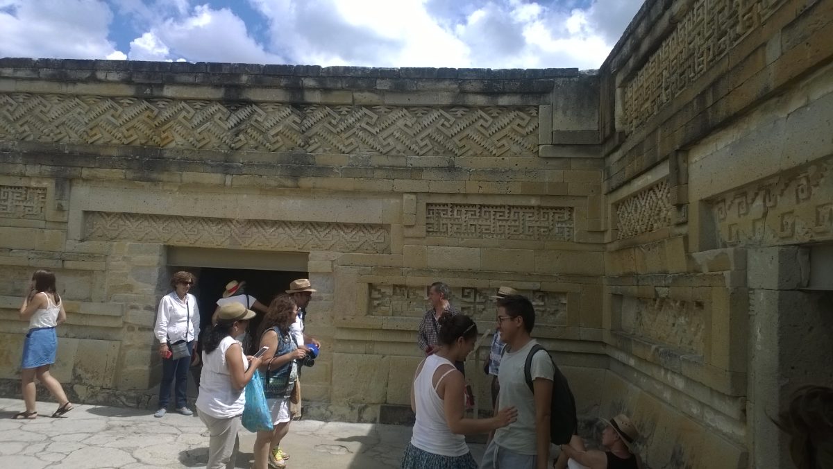 Geometric stone panel mosaics decorating a building facade at Mitla
