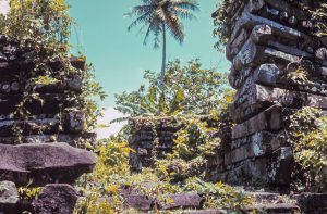Nan Madol basalt walls rising above tropical vegetation