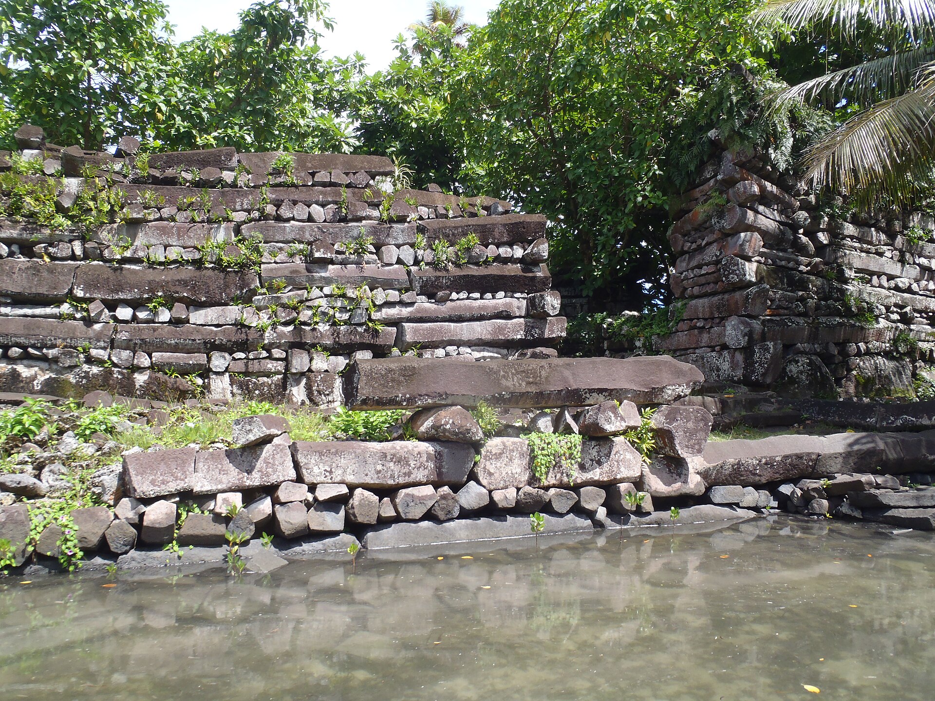 A stepped basalt terrace at the water's edge, part of the later monumental phase of building.