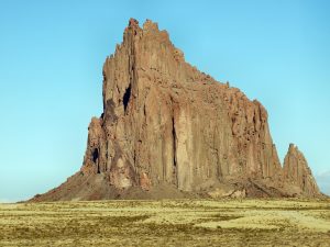 Shiprock rising from the desert plain