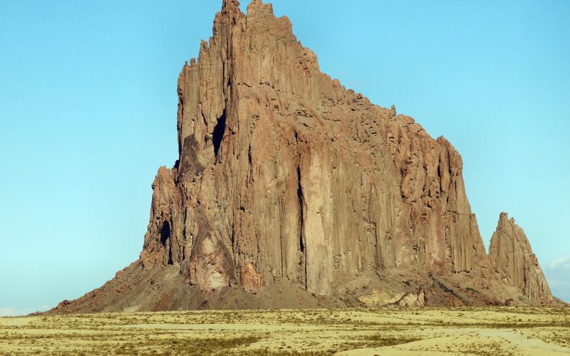 Shiprock rising from the desert plain