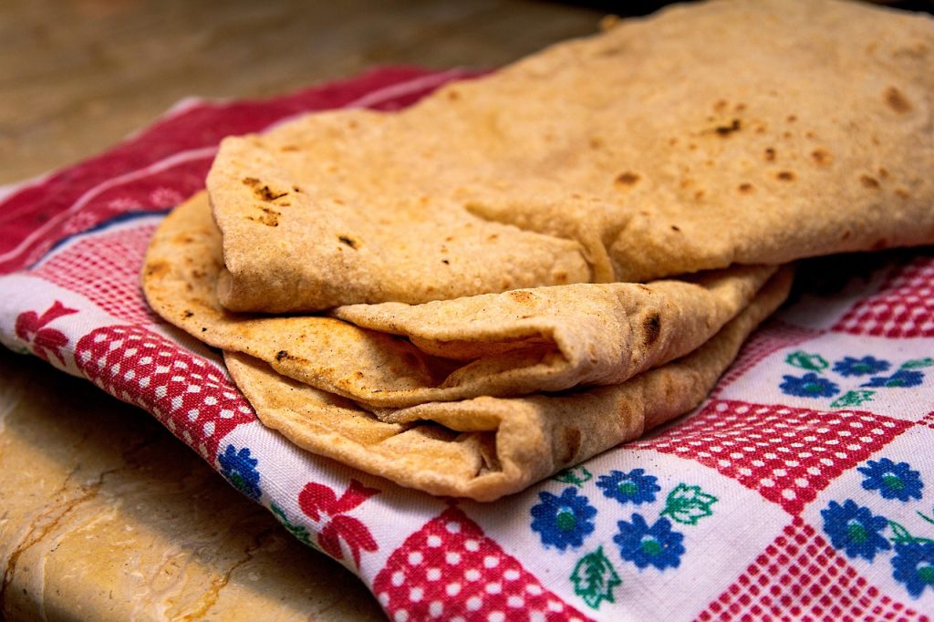 Flatbread, rice, and grilled meats anchor the Pashtun table.