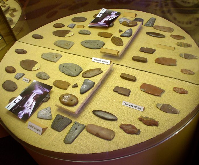 Stone gorgets and atlatl weights crafted by the Poverty Point culture