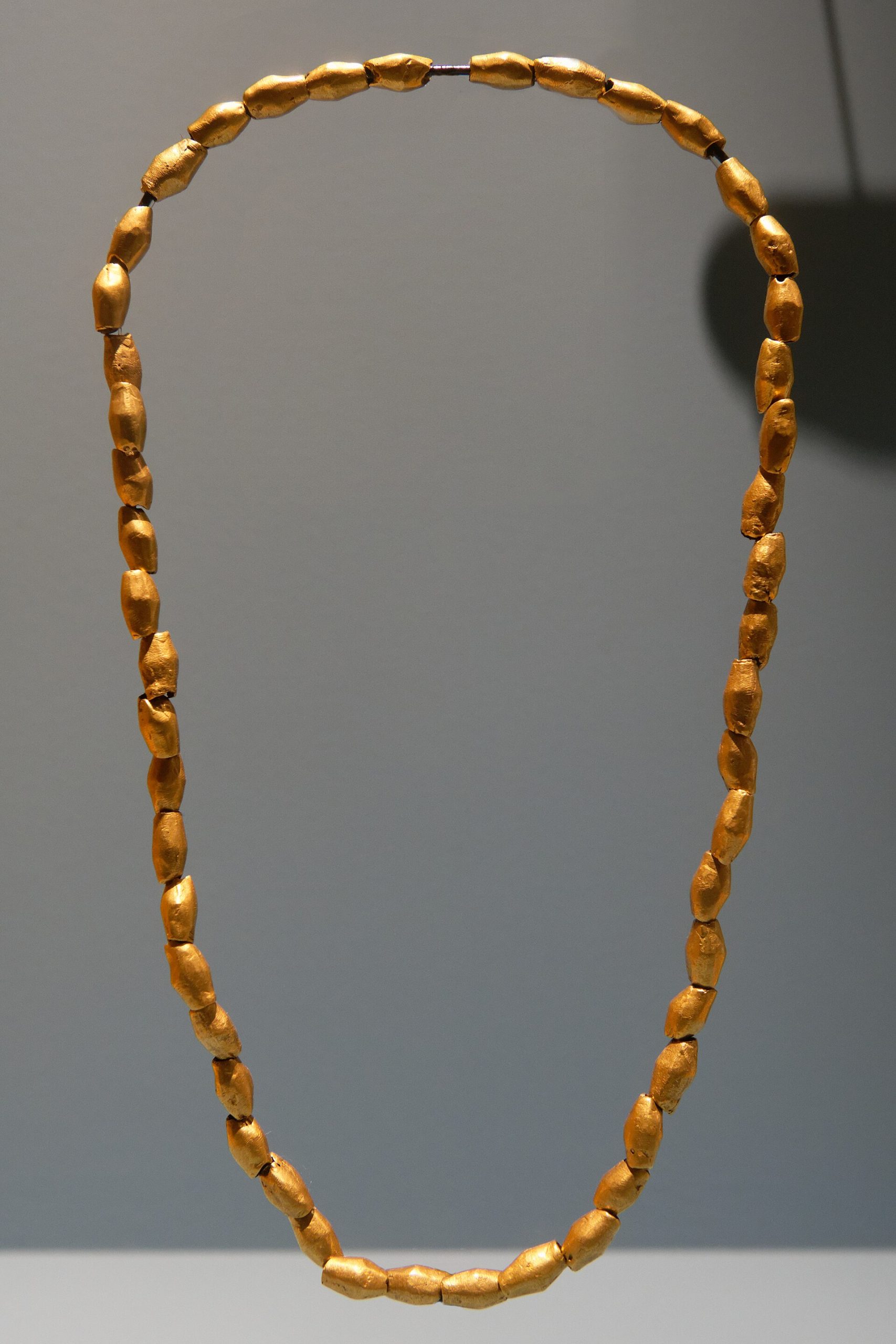 A necklace strung from beads of coloured stone and shell, materials that travelled to Sarazm from far-off sources.