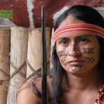 A Shuar man with traditional face painting in Ecuador