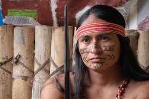 A Shuar man with traditional face painting in Ecuador