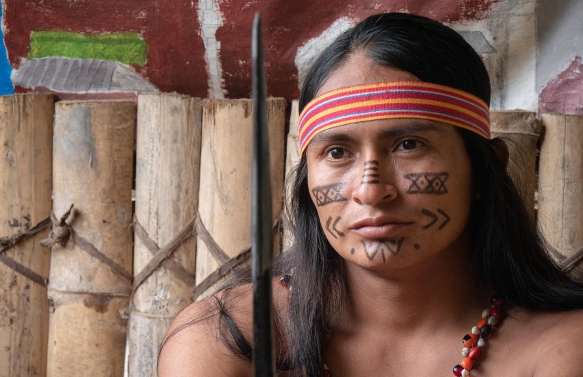 A Shuar man with traditional face painting in Ecuador