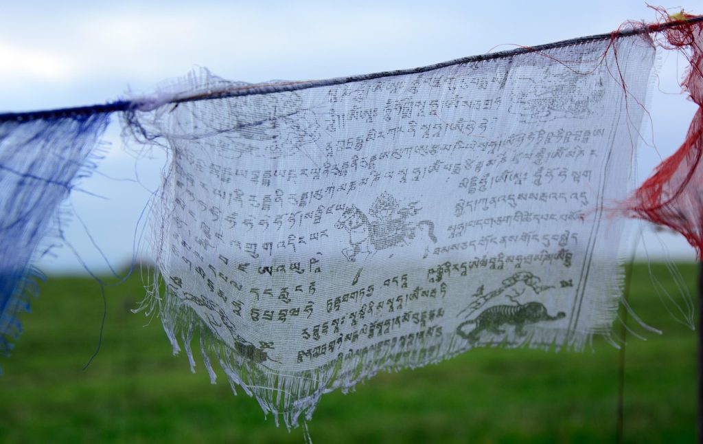 Prayer flags flutter their blessings on the mountain wind.