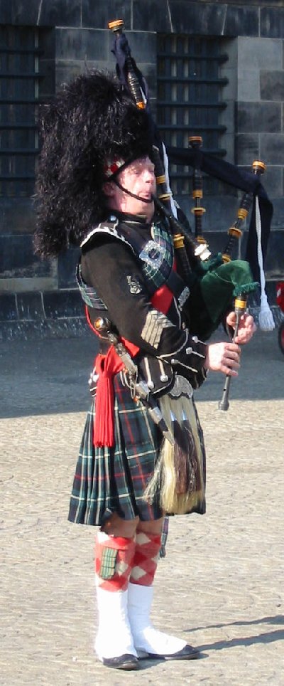 A piper playing the Great Highland bagpipe