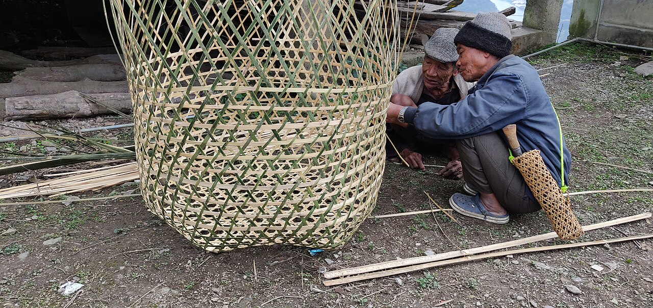 Elderly Adi people displaying their skilled craftsmanship