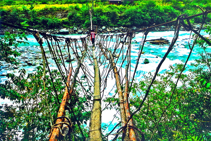 A traditional cane bridge slung across the gorge, the old way across the Dulong River