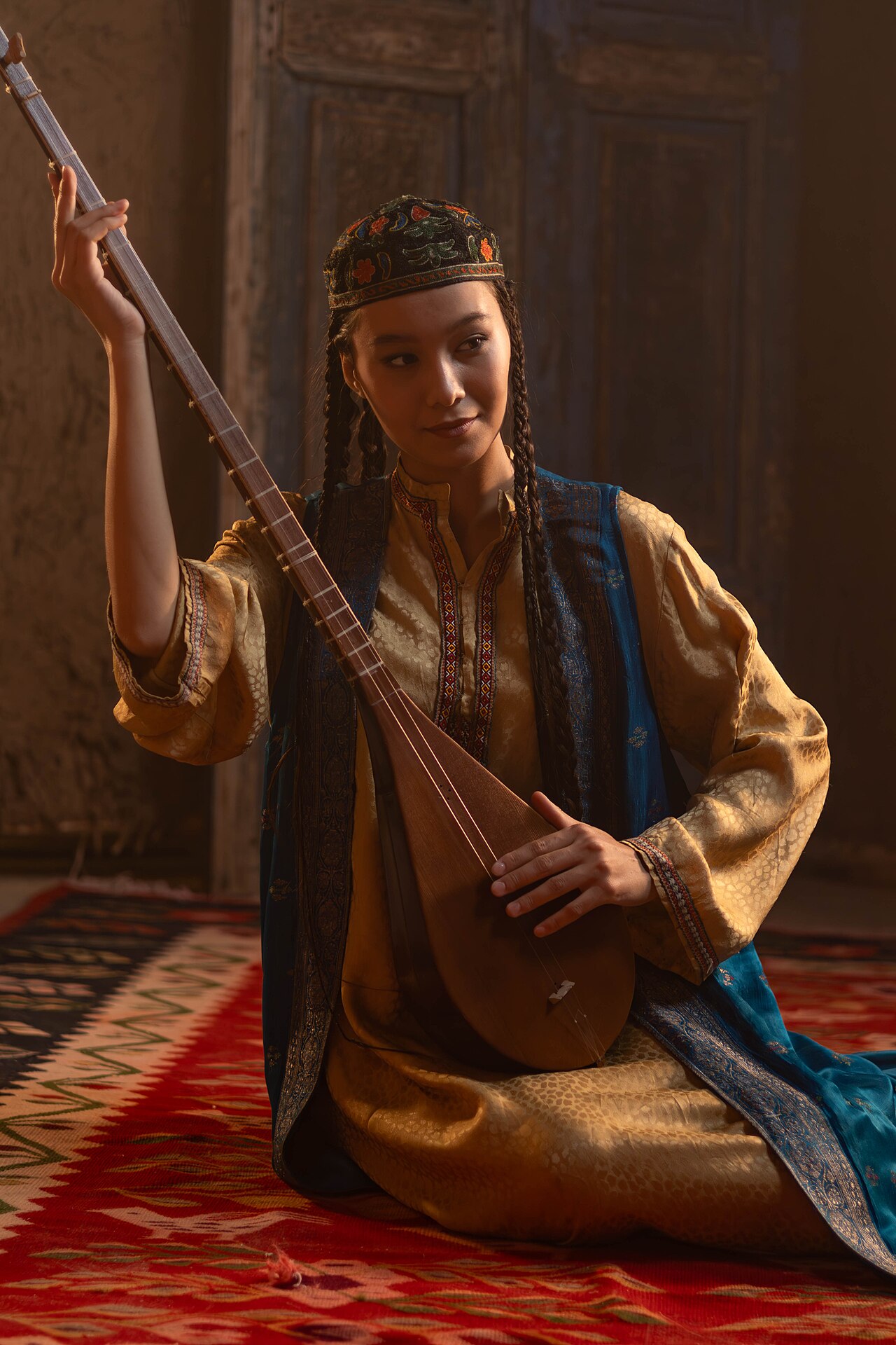 An Uzbek girl playing the dutar, a beloved instrument of the people