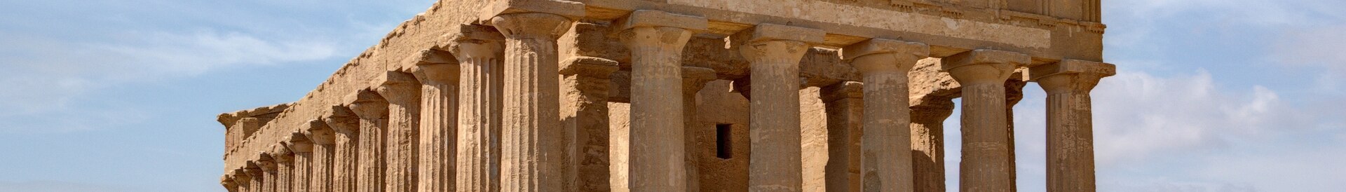 The golden Doric columns of the Temple of Concordia at sunset.