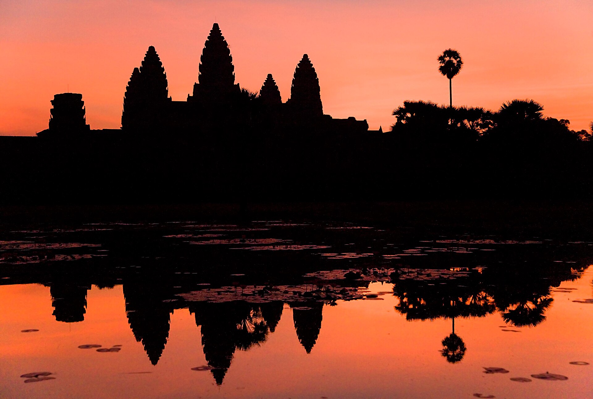 Angkor Wat reflected in its moat at dawn, the largest religious monument in the world.