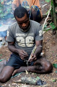 Making a hunting net, a craft shared by the forest peoples of Central Africa.