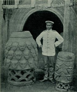 Sultan Njoya with the royal war drums, around the early twentieth century.