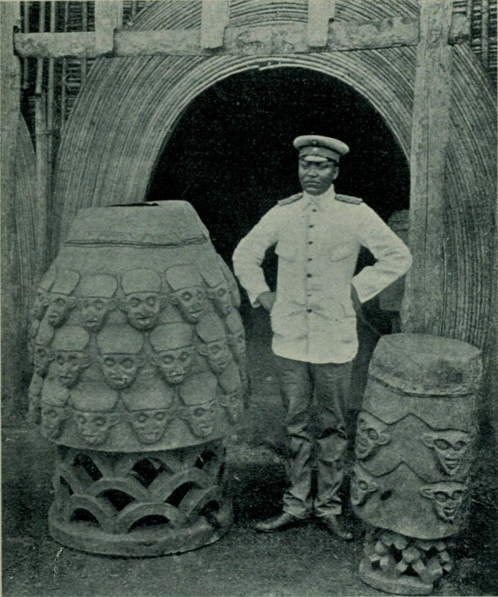 Sultan Njoya with the royal war drums, around the early twentieth century.