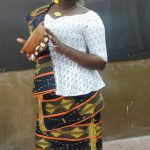 A Baoulé woman in kita cloth with a calabash; the Baoulé are the largest people of Côte d'Ivoire.