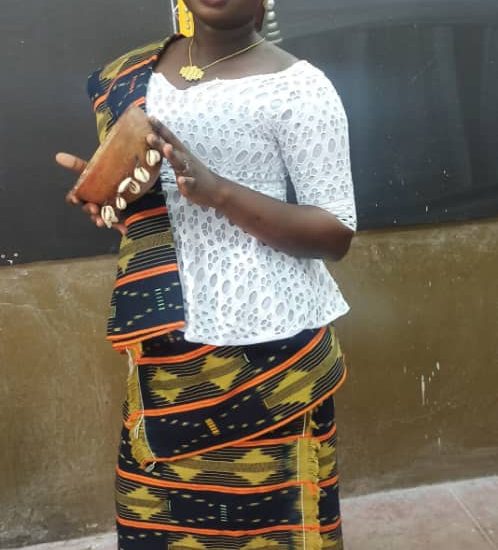 A Baoulé woman in kita cloth with a calabash; the Baoulé are the largest people of Côte d'Ivoire.