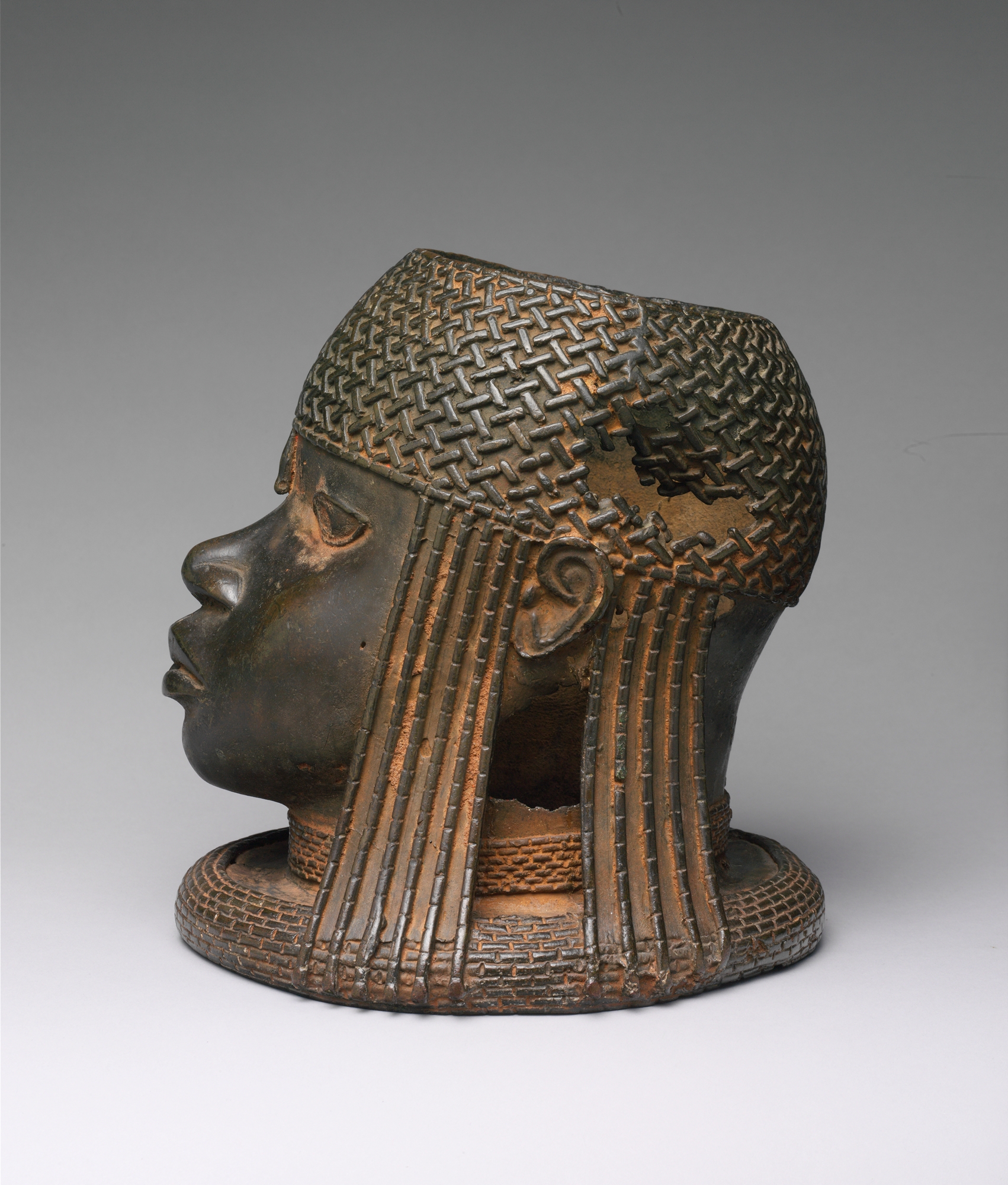 A commemorative brass head of an Oba of Benin, cast to honour a deceased ruler on his ancestral altar