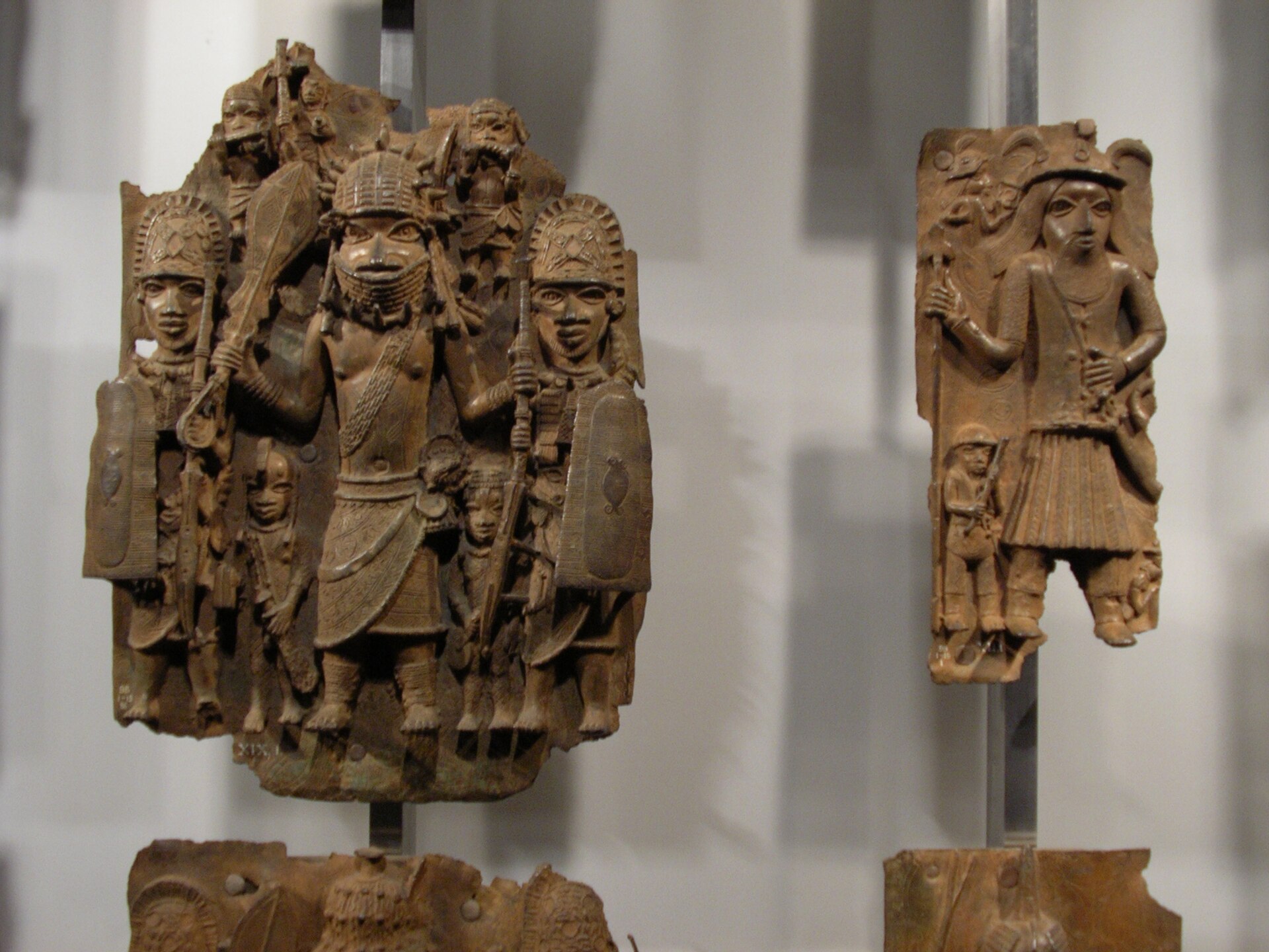 A cast brass plaque from the royal palace of Benin, depicting court officials in ceremonial dress