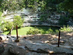 The Sacred Cenote, a natural sinkhole into which offerings and sacrifices were cast