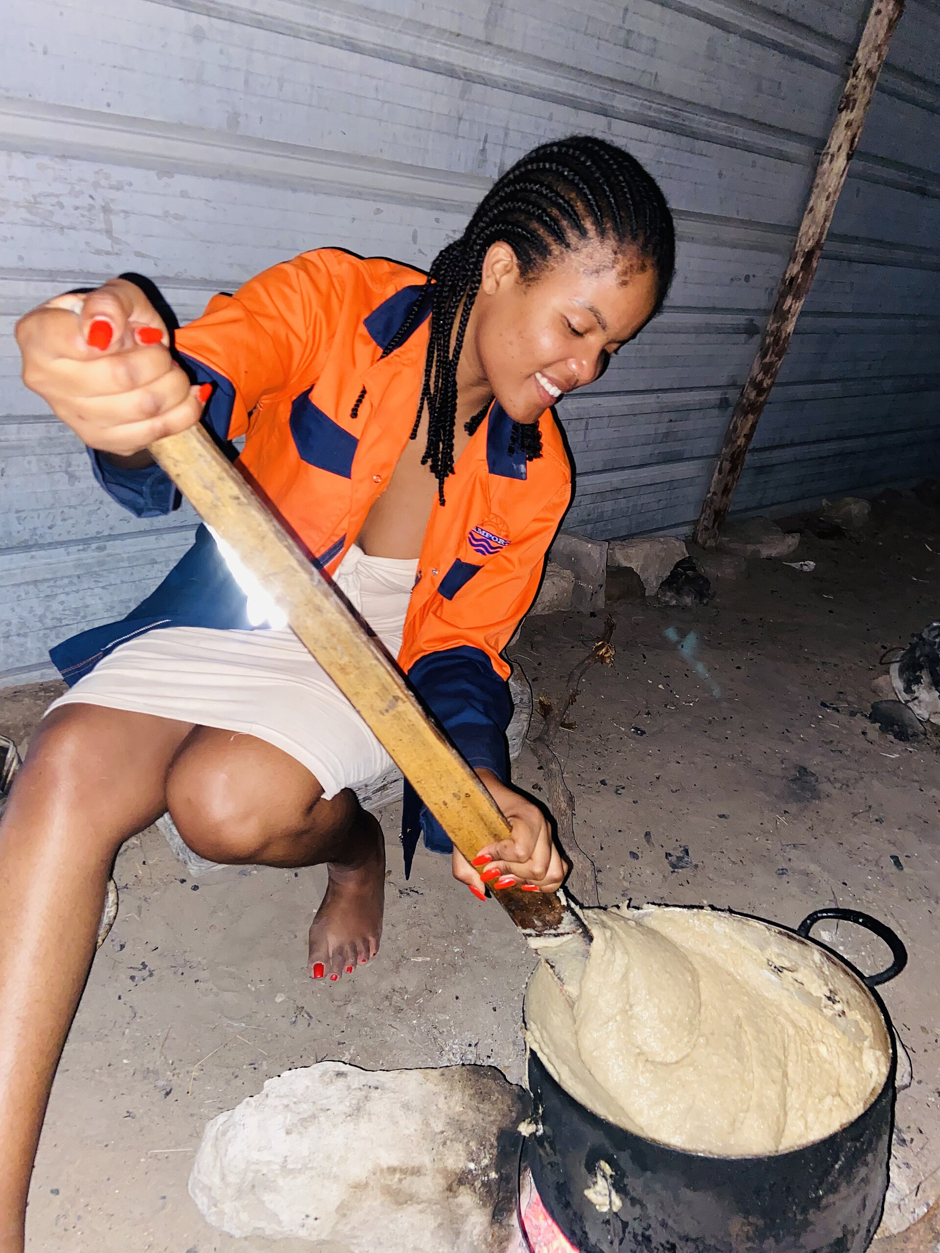 Cooking mahangu porridge, a millet staple of northern Namibia.