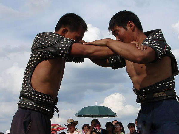 Two Daur men wrestling