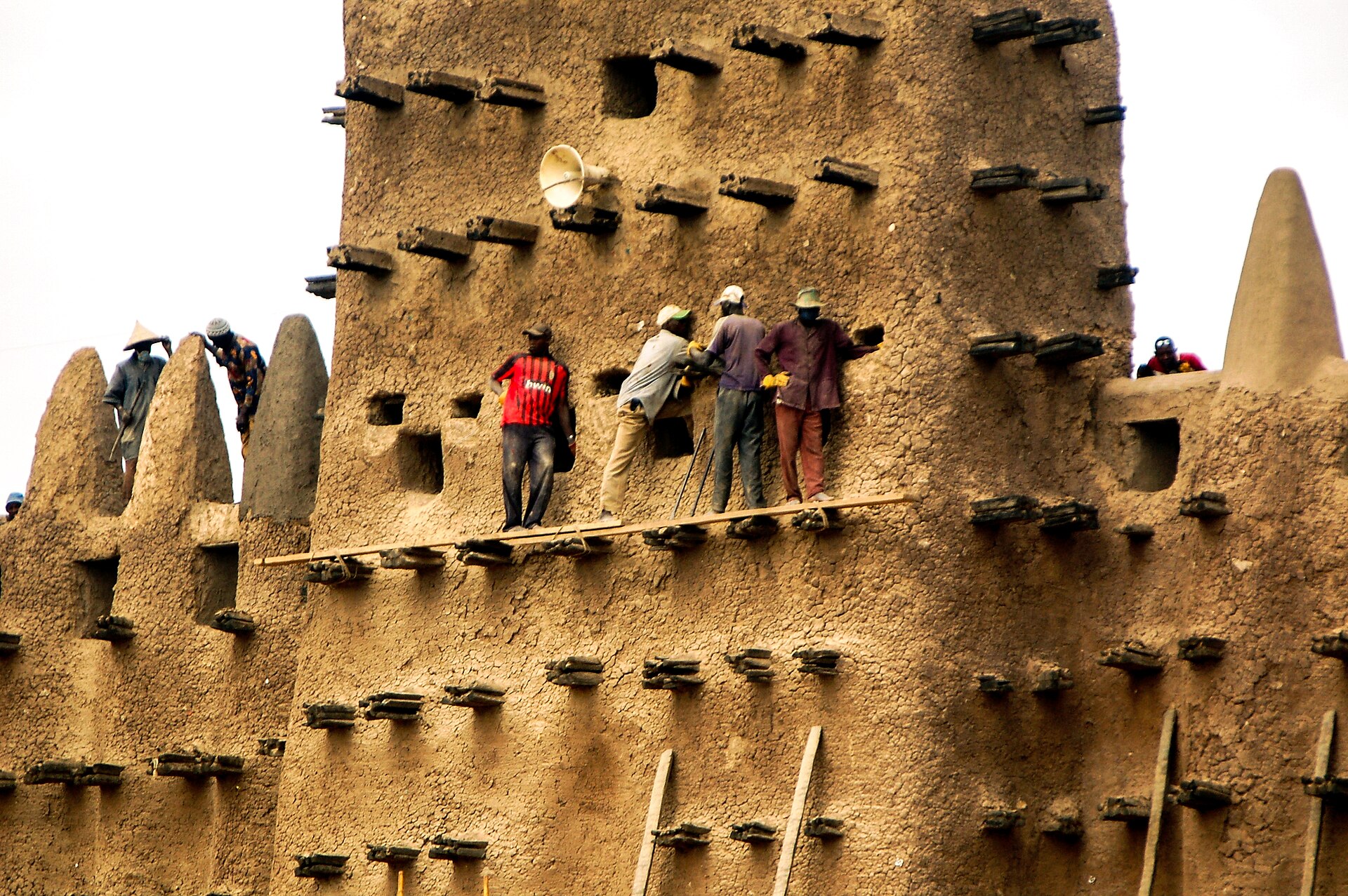 The mud-plastered walls and projecting beams of Djenne's architecture.