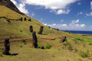 Moai standing on the slopes of Rano Raraku, buried up to their shoulders in the hillside.