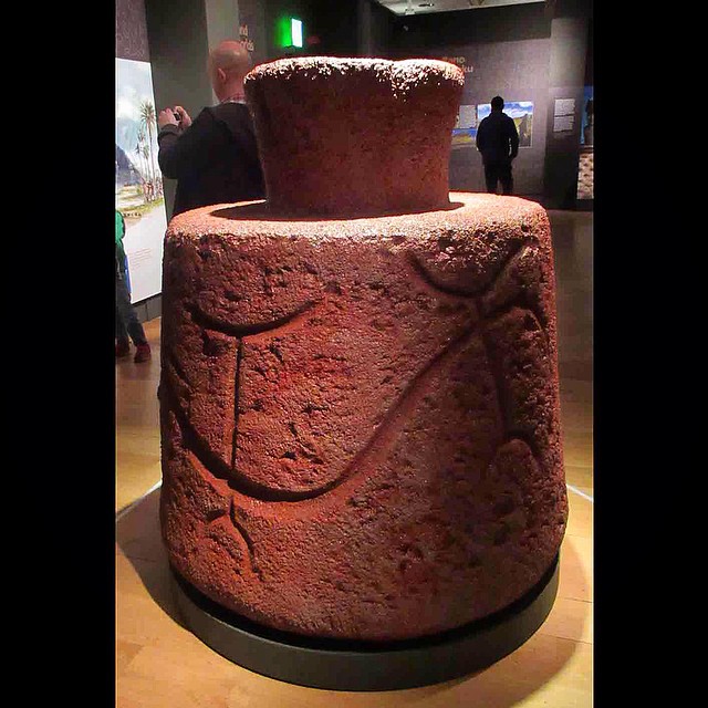 A moai crowned with a pukao, the red stone topknot representing a headdress or hair.