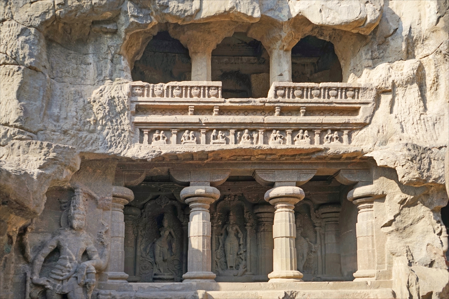 A dramatic relief panel carved into the rock at Ellora.