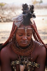 A Himba woman with her ochre-reddened skin and elaborate hair, in northwest Namibia.