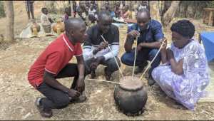 Rwandans sharing traditional drink; the Hutu are the majority in Rwanda and Burundi.