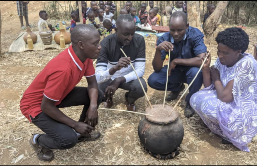 Rwandans sharing traditional drink; the Hutu are the majority in Rwanda and Burundi.