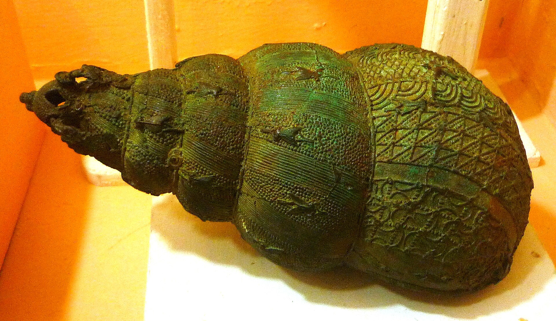 A ceremonial bronze vessel in the form of a snail shell from Igbo-Ukwu, of extraordinary delicacy