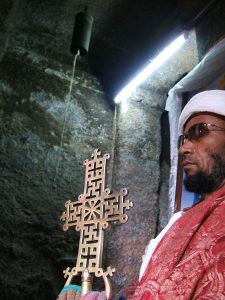 An Ethiopian Orthodox priest holding a processional cross at Lalibela.