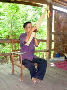 A musician playing the khaen, the reed mouth-organ of Laos