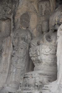 The cliffs of the Longmen Grottoes, honeycombed with Buddhist carvings.