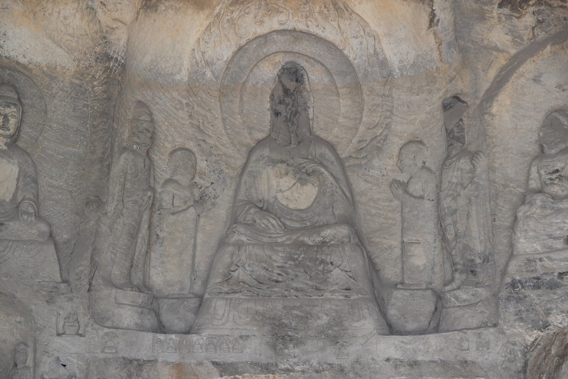 A great seated Buddha in a cave of the Longmen Grottoes.