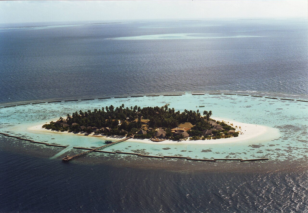 A low coral island of the Maldives, ringed by reef and lagoon