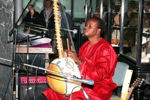 A jali, or griot, playing the kora, the great tradition of Mande music.