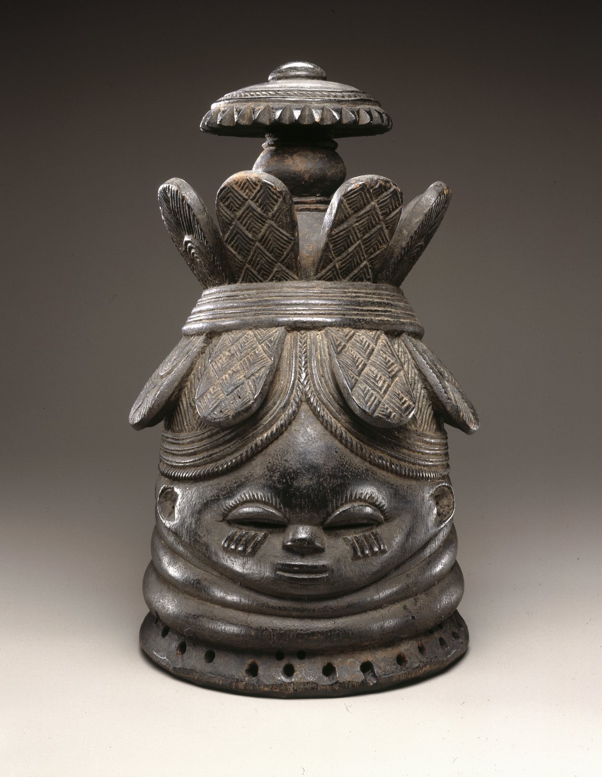 A carved wooden helmet mask, a masterpiece of Mende sculpture.