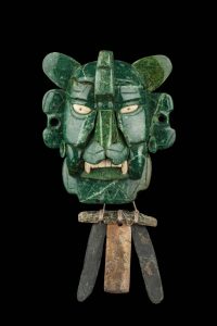 A Zapotec jade and stone ornament in the style associated with Monte Albán